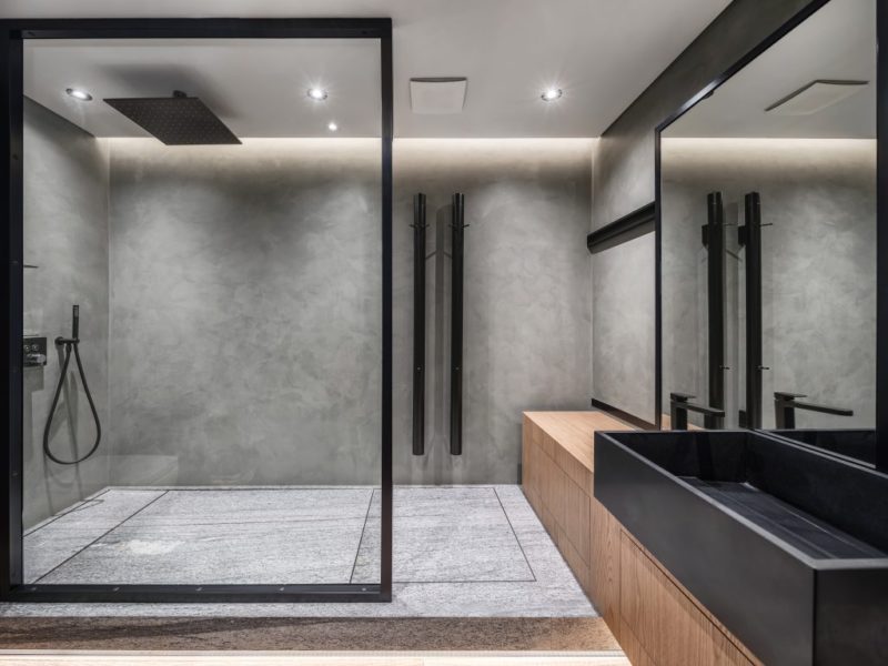 Bathroom in a modern style with gray tiled walls.